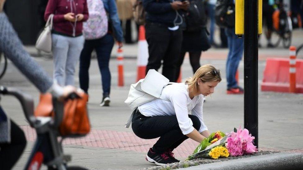 Woman laying flowers