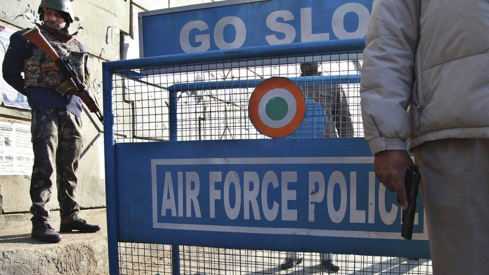 Indian security forces stand guard at an air force base near the Pakistani border