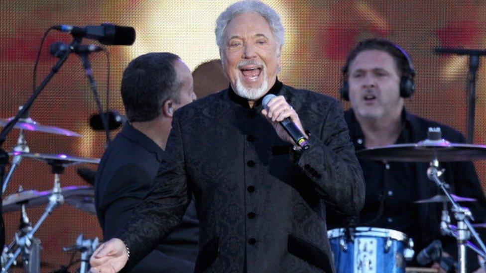 Sir Tom Jones performing on stage