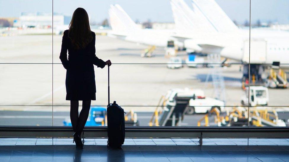 woman waiting for aeroplane