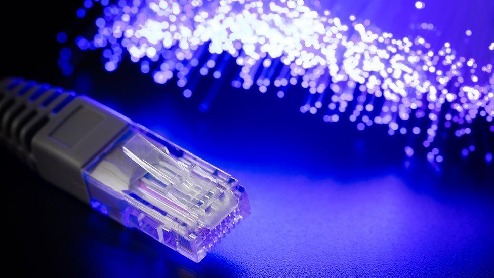 A stock image of an ethernet cable and optical fibre