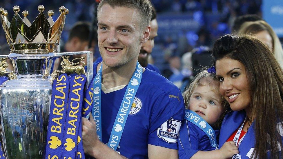 Jamie Vardy lifts the trophy as he celebrates winning the Barclays Premier League as partner Rebekah Nicholson looks on