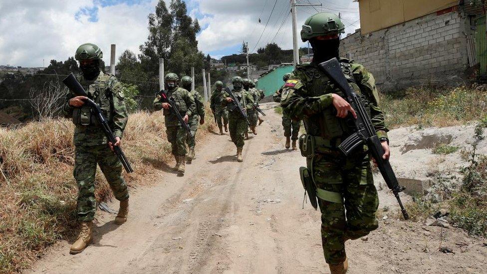 Soldiers patrol a street prior to Sunday's presidential election, in Quito, Ecuador, August 14, 2023.