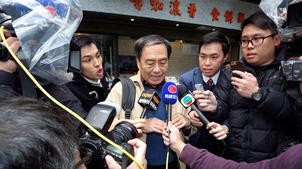 Bookseller Lee Bo, centre, speaks to media near his home in Hong Kong Friday, March 25, 2016