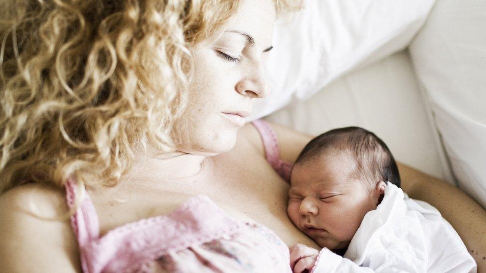 sleeping woman with new born baby