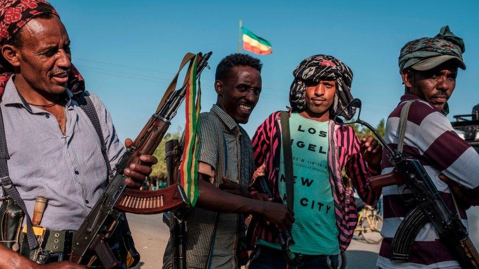 Members of the Amhara militia stand in a street of Mai Kadra, Ethiopia, on November 21, 2020.