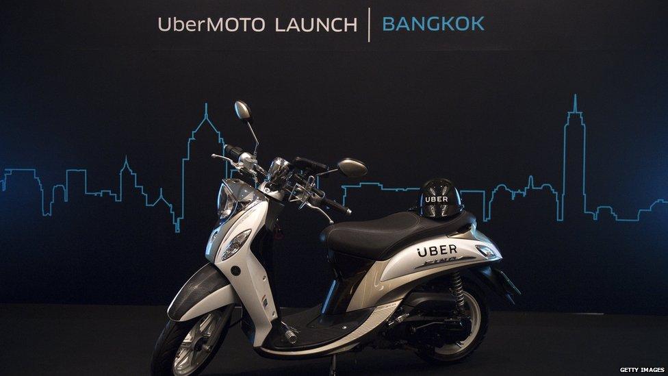 A motorbike is parked on a stage during the launch of UberMOTO at a hotel in Bangkok on February 24, 2016.