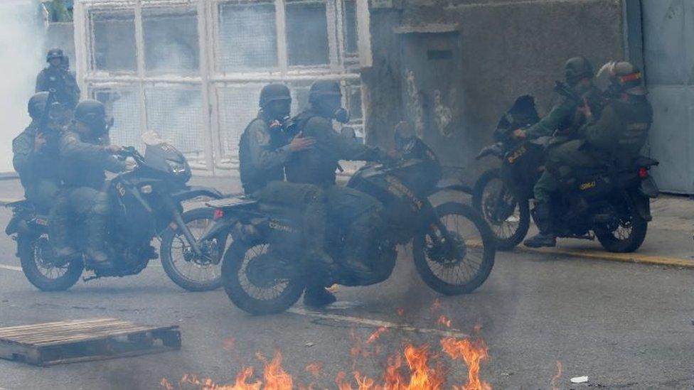 Riot police take position while clashing with opposition supporters rallying against President Nicolas Maduro in Caracas,(03 May 2017)