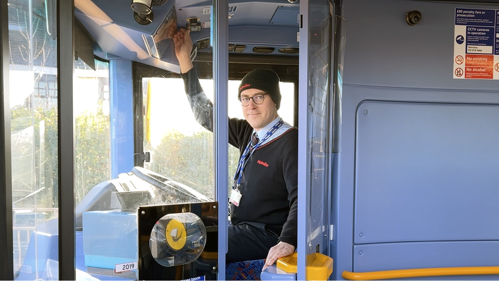 Tommy Cooling in bus driver's seat