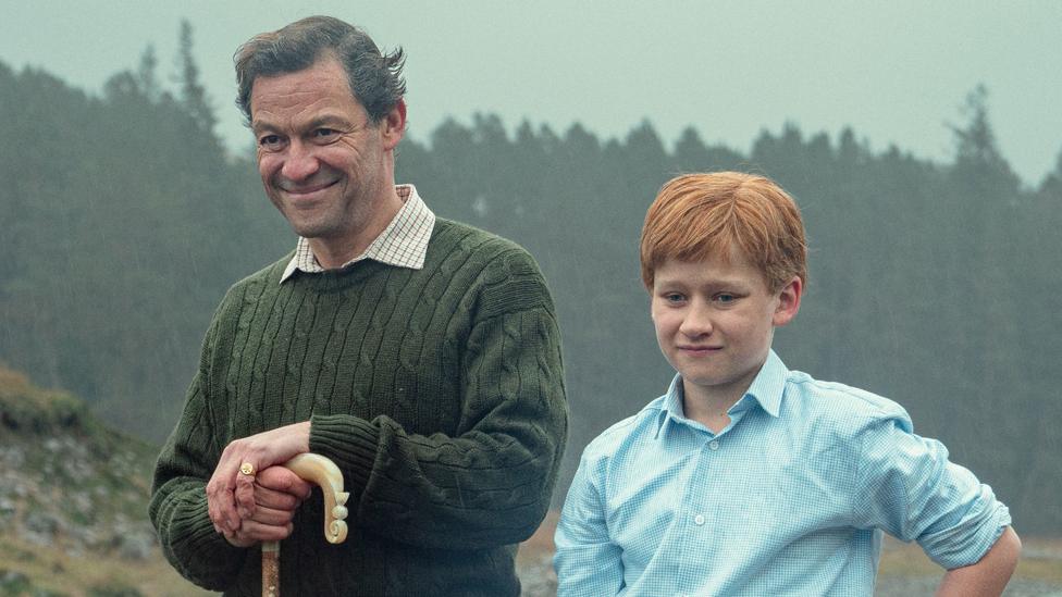 Fflyn Edwards and Dominic West in an episode of The Crown