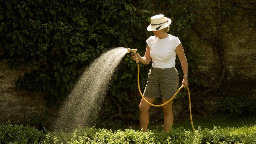 Woman with hosepipe