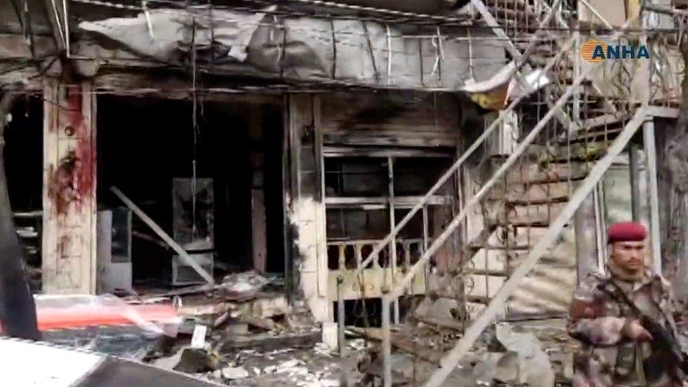 Screengrab of video published by the Syrian Kurdish Hawar News Agency (ANHA) showing the aftermath of a suicide bomb attack in Manbij, Syria (16 January 2019)