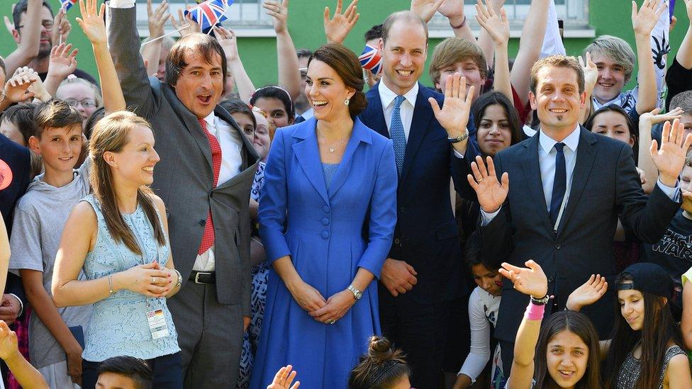 The royal couple were greeted with cheers and high fives by children in Berlin