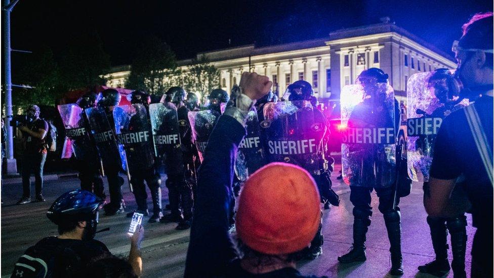 Police and protesters in Kenosha