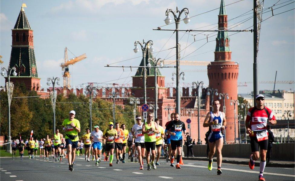 Runners race past the Kremlin during the Moscow Marathon