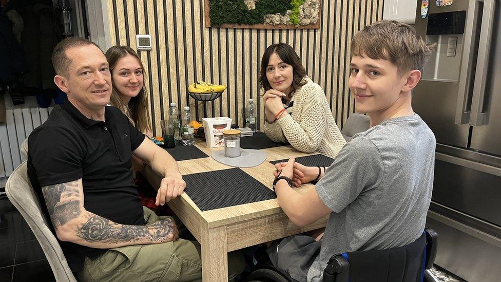 Family sat around kitchen table