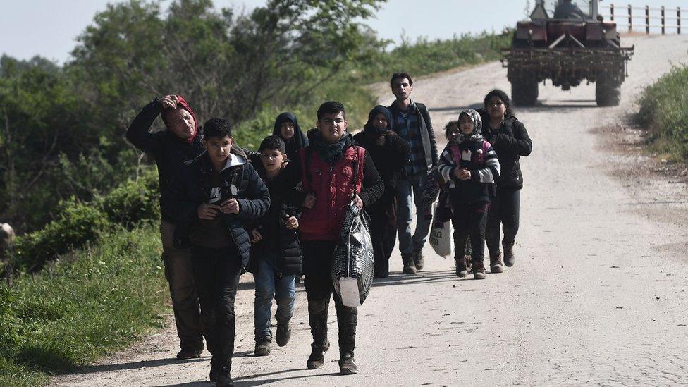 Group of people walking along a road