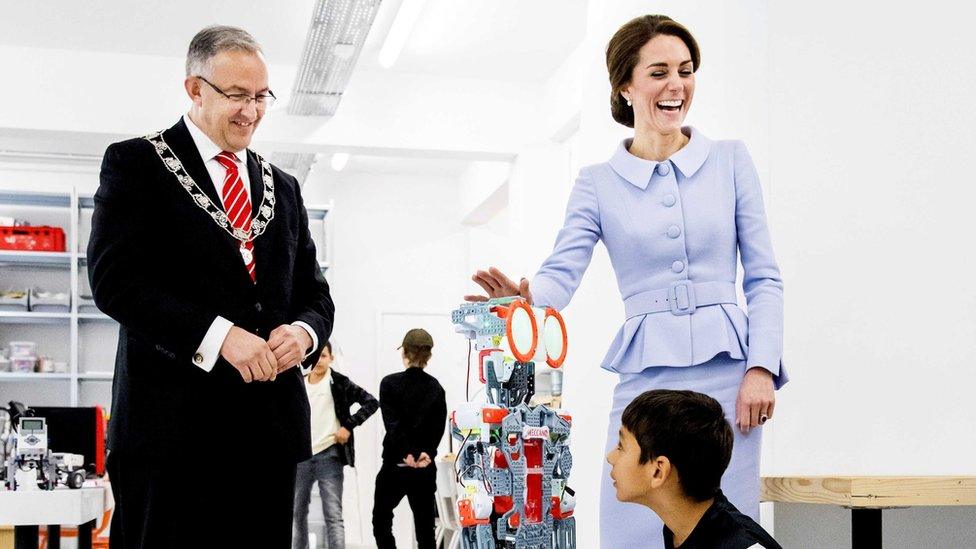 The duchess shaking hands with a robot