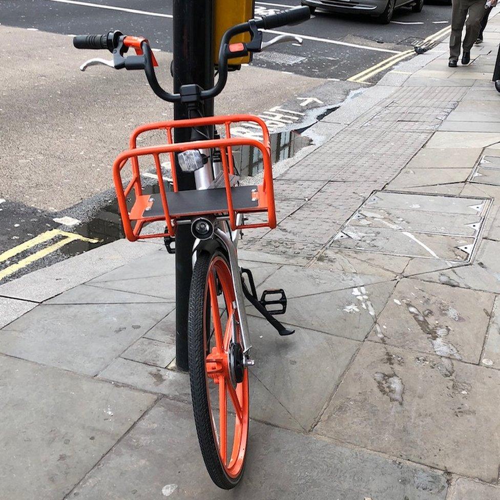 A bike leaning against a pedestrian crossing