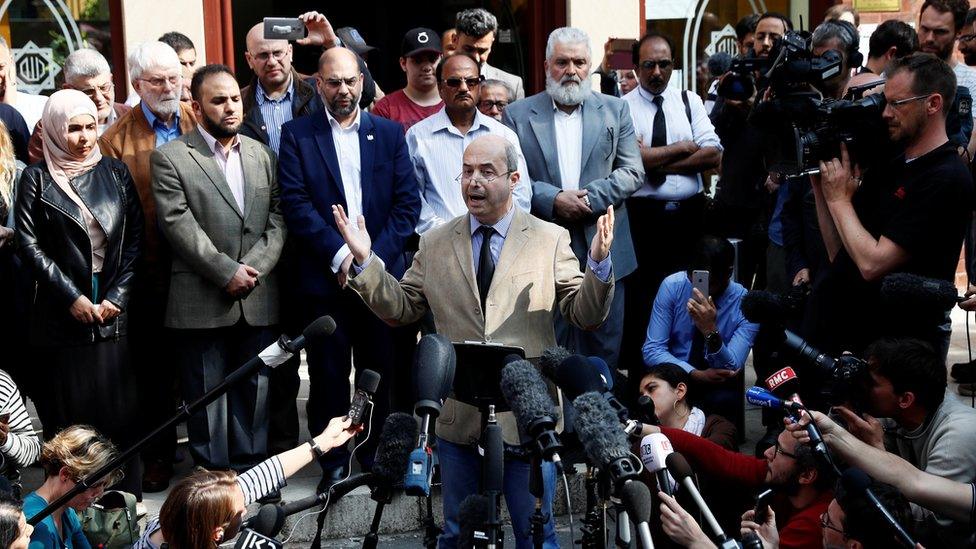 Fawzi Haffar, a trustee at the Didsbury mosque, speaks to journalists outside the mosque in Manchester