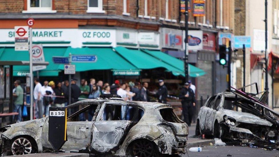 Attacking police cars in the riots