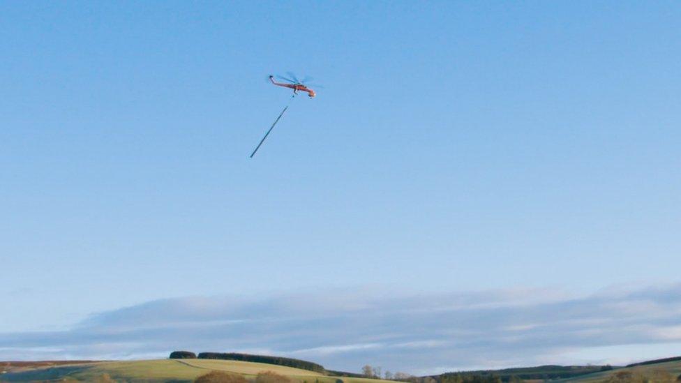 Helicopter and electricity towers