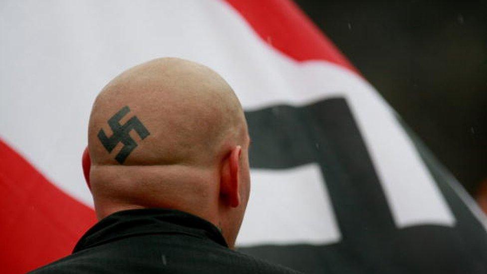 A white supremacist marches in Illinois in 2009