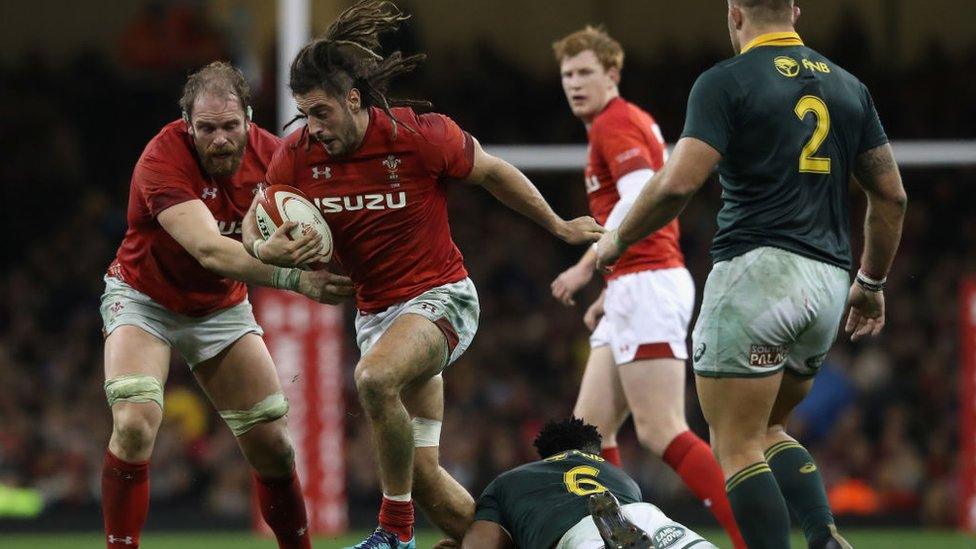 Josh Navidi breaking a tackle by South Africa captain Siya Kolisi