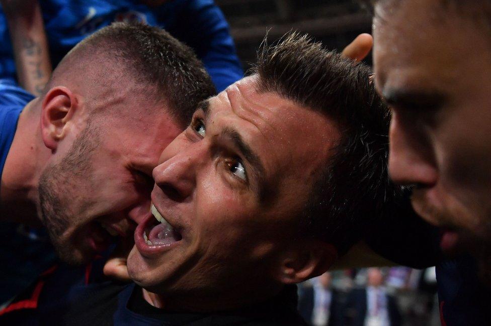 Croatia's forward Mario Mandzukic (C) celebrates with teammates after scoring his team's second goal during the Russia 2018 World Cup semi-final football match