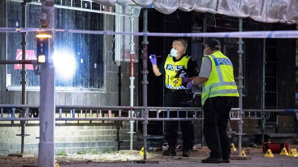 Policemen search the scene after a shooting in the centre of the southern Swedish city of Malmo on June 18, 2018