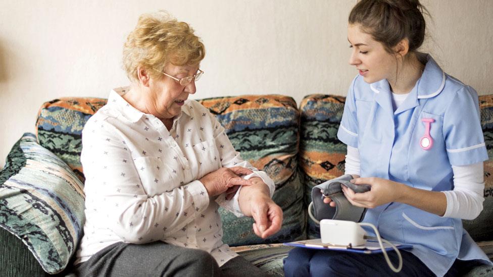 Stock image of a care worker and an elderly client