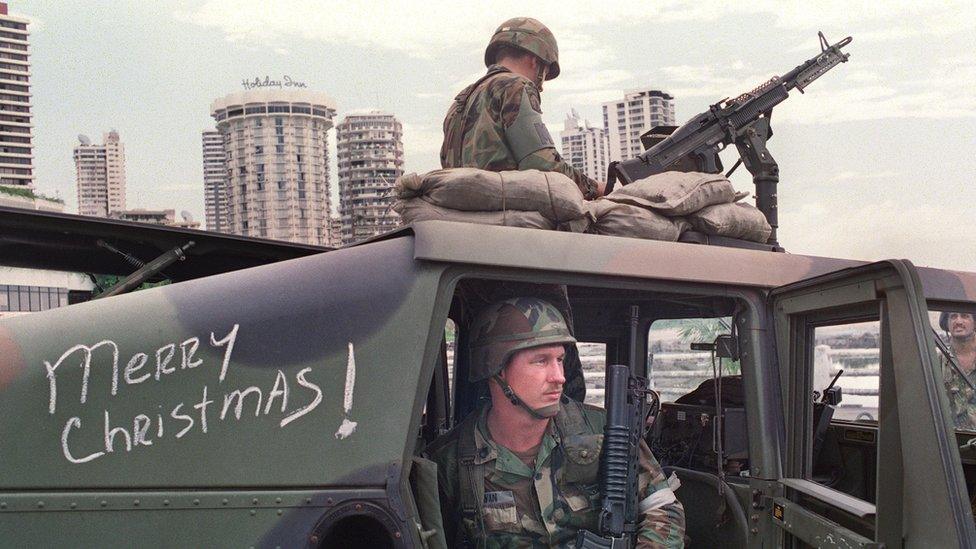 US soldiers man their security position outside the Vatican embassy in Panama City where Panamanian General Manuel Noriega is seeking asylum, during Operation Just Cause, on December 25, 1989