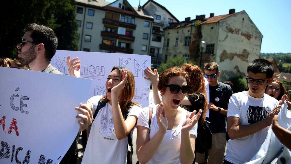 Bosnian high school students hold placards during a protest against segregation at schools in Travnik, Bosnia and Herzegovina, on 20 June 2017