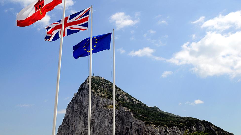 Flags of Gibraltar, Union and EU flying above the rock of Gibraltar