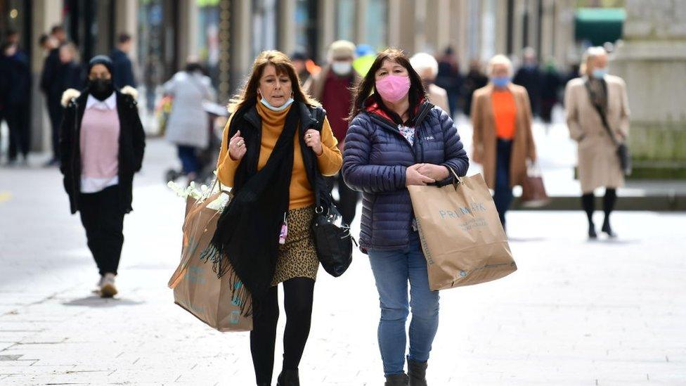 Two women walking down the street