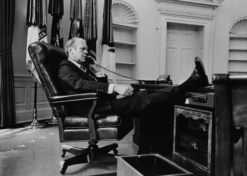 President Gerald R Ford takes a call at his desk in the Oval Office, 1974