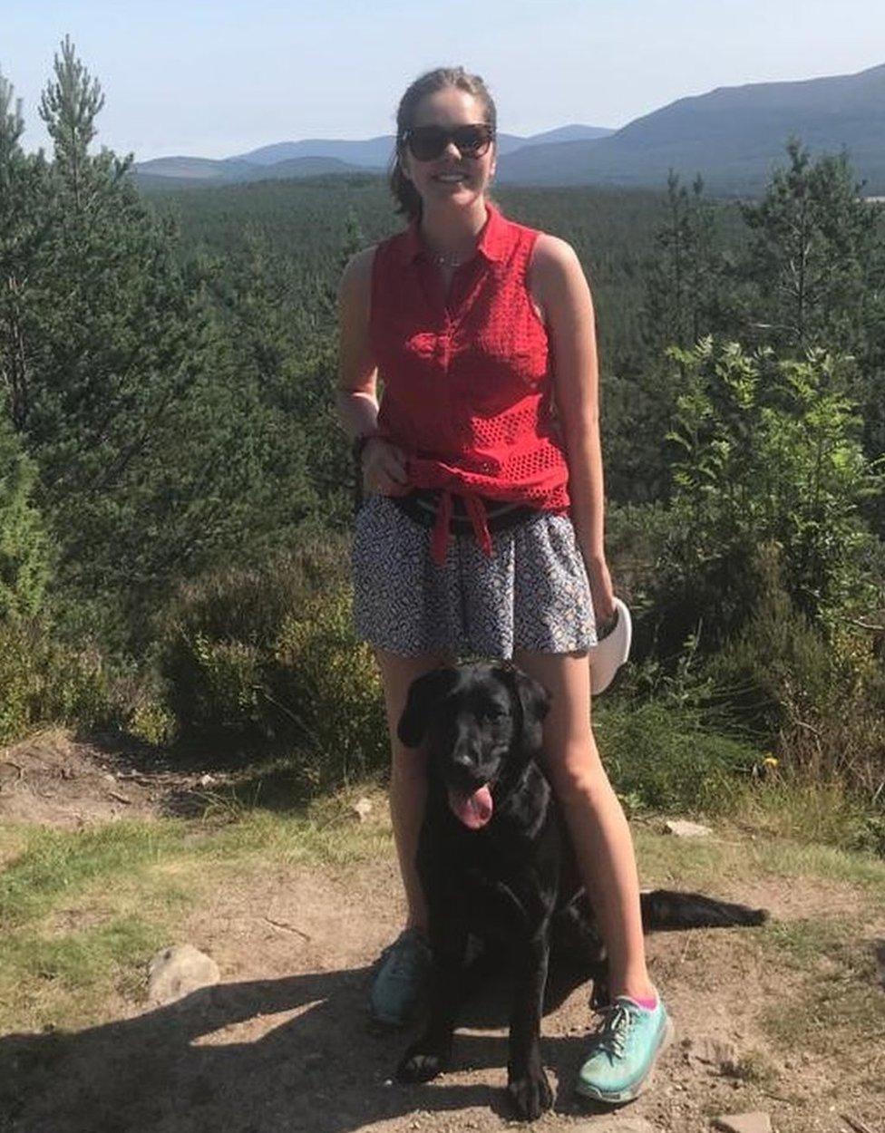 Amy with family dog Archie, a black Labrador.