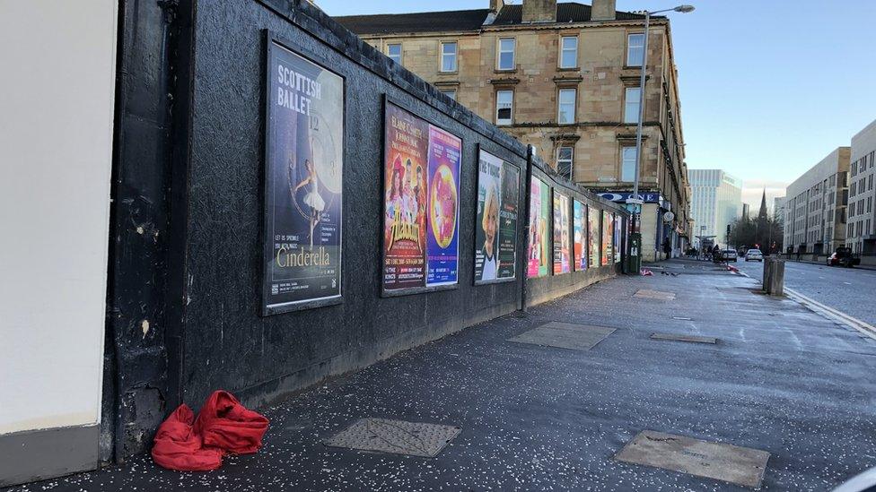 Suit discarded on pavement