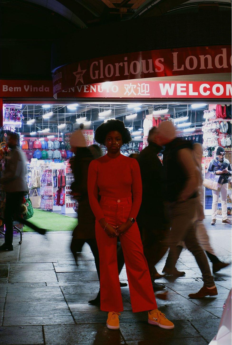 A woman standing in a busy high street