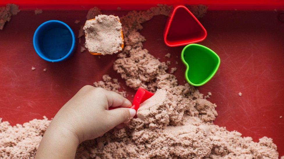 Child playing with sand