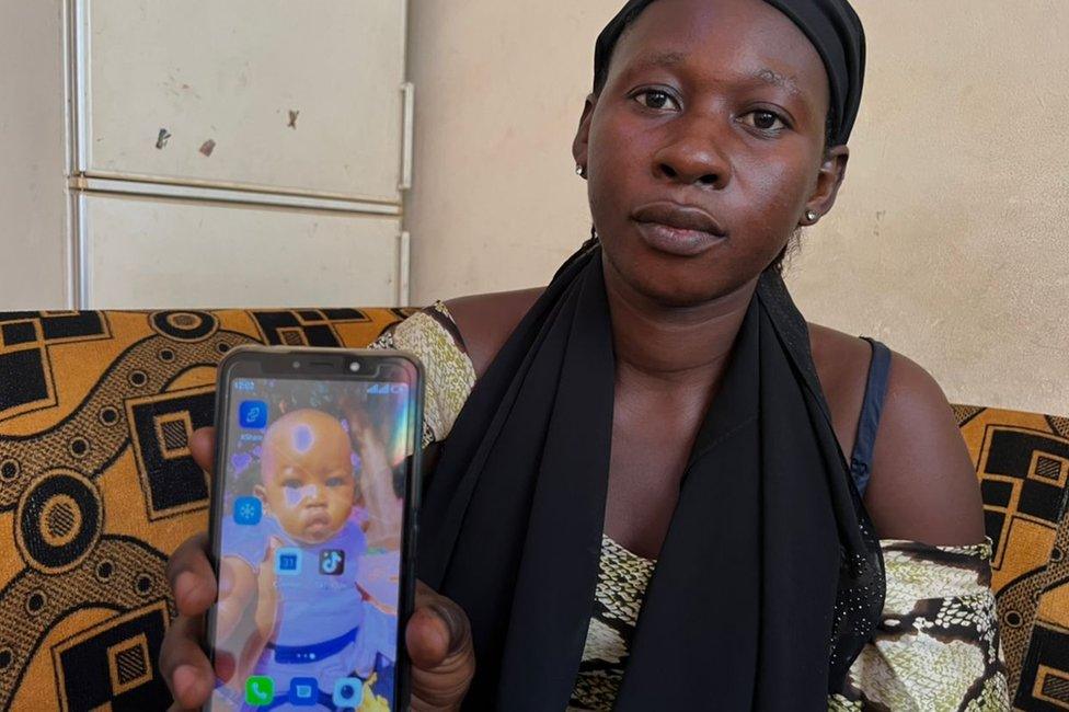 Mother showing a picture of her child