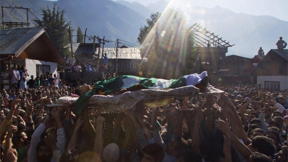 Kashmiri Muslims shout freedom slogans as they carry the body of Nasir Shafi during his funeral procession on the outskirts of Srinagar, Indian controlled Kashmir, 17 September