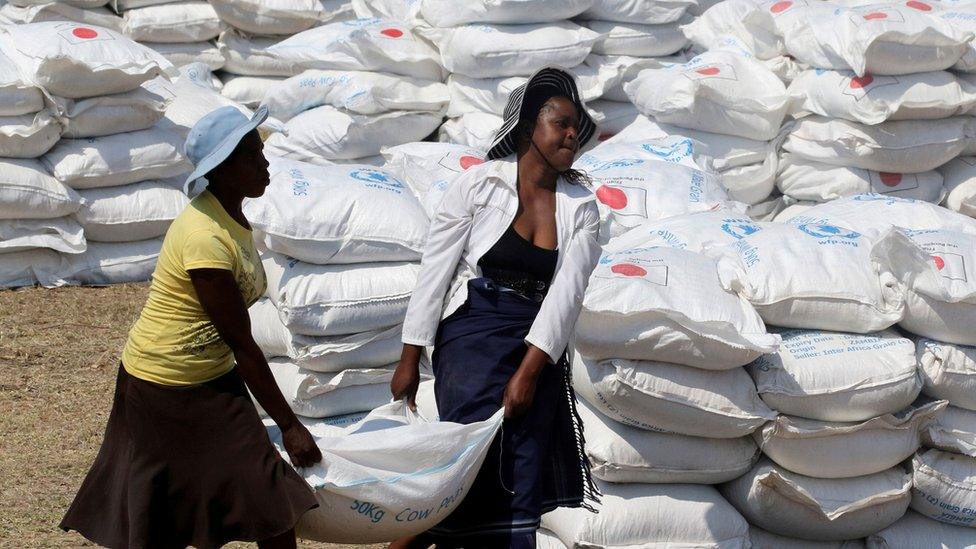 Villagers collect food aid provided by the United Nations World Food Programme (WFP) at a distribution point in Bhayu, Zimbabwe, September 14, 2016.