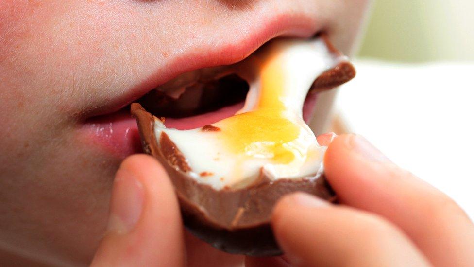 Boy eating Creme Egg