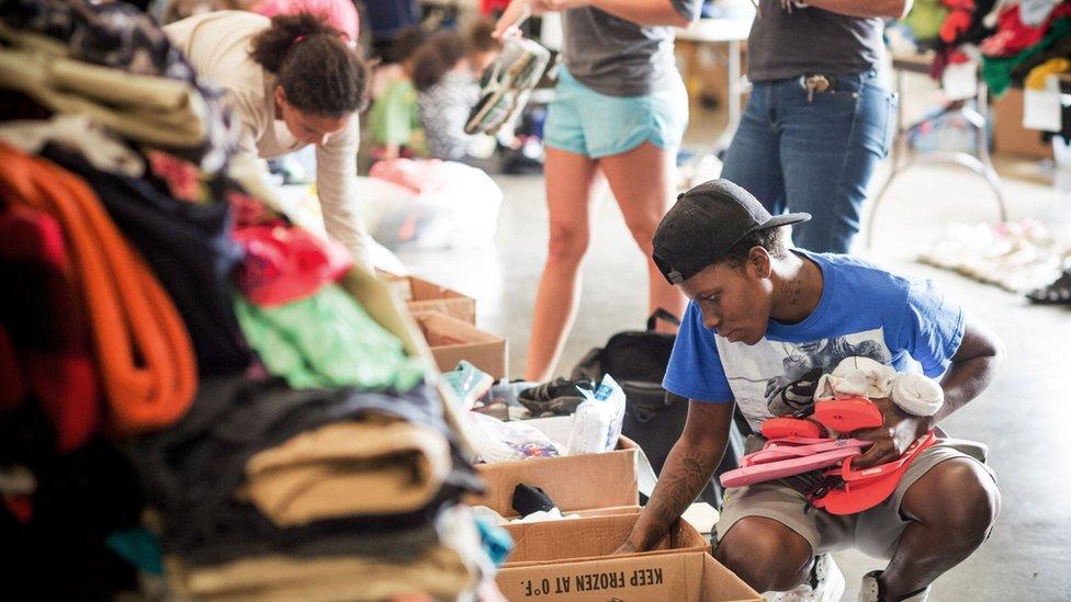 People sort through donated clothes at the Lake Charles Civic Center in Lake Charles, Louisiana on August 31, 2017.