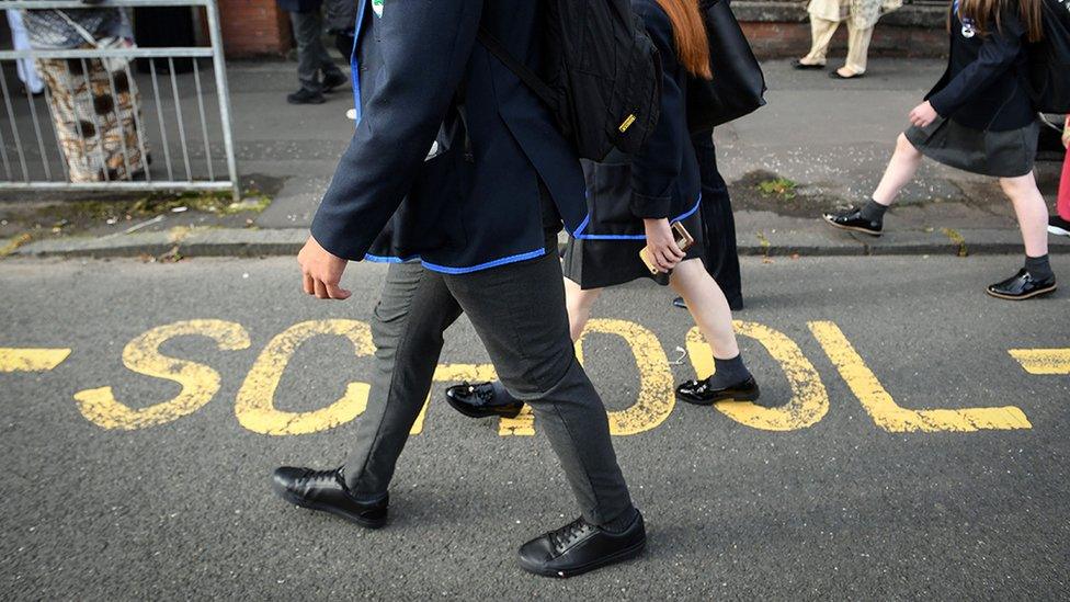 Pupils walking outside a school