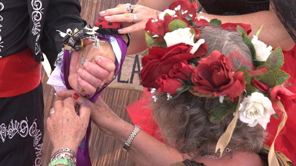 Ribbons being tied around a wrist