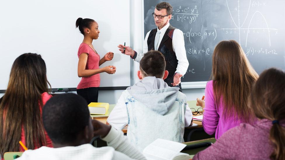 Teacher in classroom - stock photo