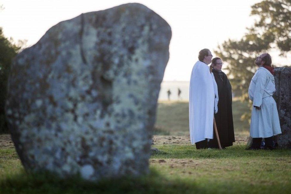 People at the Avebury stone circle in Wiltshire