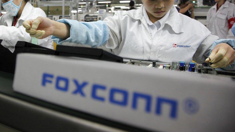 File photo of someone assembling in Foxconn factory